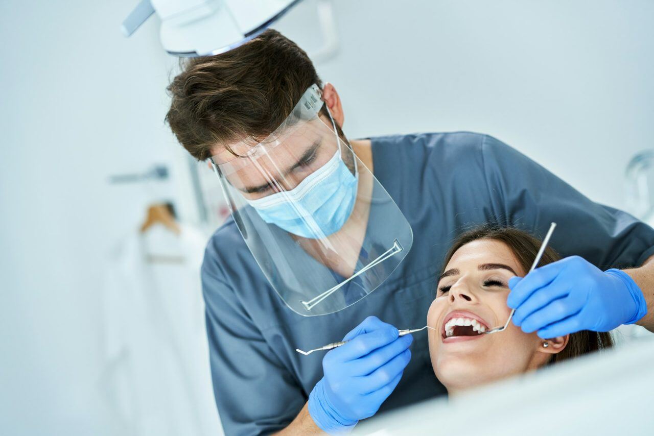 male-dentist-and-woman-in-dentist-office